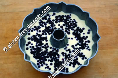 Blueberries arranged on cake batter